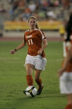 UT sophomore Niki Arlitt (#11, Forward) passes the ball to UT freshman Amanda Lisberger (#13, Midfielder).   The University of Texas women's soccer team tied 0-0 against the Texas A&M Aggies Friday night, September 27, 2008.

Filename: SRM_20080926_1929404.jpg
Aperture: f/4.0
Shutter Speed: 1/400
Body: Canon EOS-1D Mark II
Lens: Canon EF 300mm f/2.8 L IS