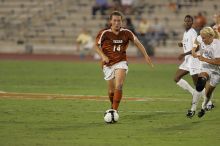 UT senior Kasey Moore (#14, Defender) brings the ball downfield.  The University of Texas women's soccer team tied 0-0 against the Texas A&M Aggies Friday night, September 27, 2008.

Filename: SRM_20080926_1935386.jpg
Aperture: f/4.0
Shutter Speed: 1/400
Body: Canon EOS-1D Mark II
Lens: Canon EF 300mm f/2.8 L IS