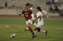 UT senior Kasey Moore (#14, Defender) brings the ball downfield.  The University of Texas women's soccer team tied 0-0 against the Texas A&M Aggies Friday night, September 27, 2008.

Filename: SRM_20080926_1935402.jpg
Aperture: f/4.0
Shutter Speed: 1/500
Body: Canon EOS-1D Mark II
Lens: Canon EF 300mm f/2.8 L IS