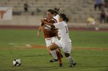 UT senior Kasey Moore (#14, Defender) brings the ball downfield.  The University of Texas women's soccer team tied 0-0 against the Texas A&M Aggies Friday night, September 27, 2008.

Filename: SRM_20080926_1935403.jpg
Aperture: f/4.0
Shutter Speed: 1/500
Body: Canon EOS-1D Mark II
Lens: Canon EF 300mm f/2.8 L IS