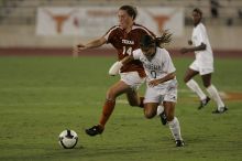 UT senior Kasey Moore (#14, Defender) brings the ball downfield.  The University of Texas women's soccer team tied 0-0 against the Texas A&M Aggies Friday night, September 27, 2008.

Filename: SRM_20080926_1935426.jpg
Aperture: f/4.0
Shutter Speed: 1/500
Body: Canon EOS-1D Mark II
Lens: Canon EF 300mm f/2.8 L IS