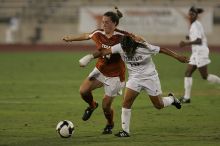 UT senior Kasey Moore (#14, Defender) brings the ball downfield.  The University of Texas women's soccer team tied 0-0 against the Texas A&M Aggies Friday night, September 27, 2008.

Filename: SRM_20080926_1935427.jpg
Aperture: f/4.0
Shutter Speed: 1/500
Body: Canon EOS-1D Mark II
Lens: Canon EF 300mm f/2.8 L IS