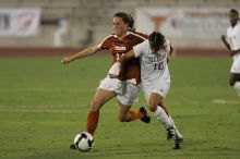UT senior Kasey Moore (#14, Defender) brings the ball downfield.  The University of Texas women's soccer team tied 0-0 against the Texas A&M Aggies Friday night, September 27, 2008.

Filename: SRM_20080926_1935428.jpg
Aperture: f/4.0
Shutter Speed: 1/400
Body: Canon EOS-1D Mark II
Lens: Canon EF 300mm f/2.8 L IS