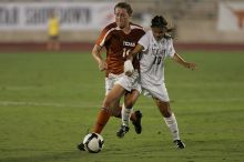 UT senior Kasey Moore (#14, Defender) brings the ball downfield.  The University of Texas women's soccer team tied 0-0 against the Texas A&M Aggies Friday night, September 27, 2008.

Filename: SRM_20080926_1935440.jpg
Aperture: f/4.0
Shutter Speed: 1/400
Body: Canon EOS-1D Mark II
Lens: Canon EF 300mm f/2.8 L IS