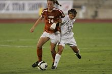 UT senior Kasey Moore (#14, Defender) brings the ball downfield.  The University of Texas women's soccer team tied 0-0 against the Texas A&M Aggies Friday night, September 27, 2008.

Filename: SRM_20080926_1935441.jpg
Aperture: f/4.0
Shutter Speed: 1/400
Body: Canon EOS-1D Mark II
Lens: Canon EF 300mm f/2.8 L IS