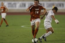 UT senior Kasey Moore (#14, Defender) brings the ball downfield.  The University of Texas women's soccer team tied 0-0 against the Texas A&M Aggies Friday night, September 27, 2008.

Filename: SRM_20080926_1935443.jpg
Aperture: f/4.0
Shutter Speed: 1/500
Body: Canon EOS-1D Mark II
Lens: Canon EF 300mm f/2.8 L IS