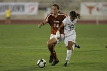UT senior Kasey Moore (#14, Defender) brings the ball downfield.  The University of Texas women's soccer team tied 0-0 against the Texas A&M Aggies Friday night, September 27, 2008.

Filename: SRM_20080926_1935449.jpg
Aperture: f/4.0
Shutter Speed: 1/500
Body: Canon EOS-1D Mark II
Lens: Canon EF 300mm f/2.8 L IS