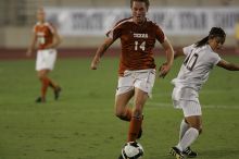 UT senior Kasey Moore (#14, Defender) brings the ball downfield.  The University of Texas women's soccer team tied 0-0 against the Texas A&M Aggies Friday night, September 27, 2008.

Filename: SRM_20080926_1935464.jpg
Aperture: f/4.0
Shutter Speed: 1/500
Body: Canon EOS-1D Mark II
Lens: Canon EF 300mm f/2.8 L IS