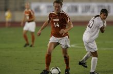 UT senior Kasey Moore (#14, Defender) brings the ball downfield.  The University of Texas women's soccer team tied 0-0 against the Texas A&M Aggies Friday night, September 27, 2008.

Filename: SRM_20080926_1935465.jpg
Aperture: f/4.0
Shutter Speed: 1/500
Body: Canon EOS-1D Mark II
Lens: Canon EF 300mm f/2.8 L IS