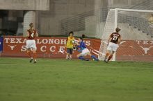 UT senior Dianna Pfenninger (#8, Goalkeeper) dives for the ball as UT junior Emily Anderson (#21, Forward) and UT senior Jill Gilbeau (#4, Defender and Midfielder) watch.  The University of Texas women's soccer team tied 0-0 against the Texas A&M Aggies Friday night, September 27, 2008.

Filename: SRM_20080926_1938563.jpg
Aperture: f/4.0
Shutter Speed: 1/400
Body: Canon EOS-1D Mark II
Lens: Canon EF 300mm f/2.8 L IS