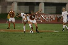 UT freshman Kylie Doniak (#15, Midfielder) tackles the ball as UT sophomore Erica Campanelli (#19, Defender) watches.  The University of Texas women's soccer team tied 0-0 against the Texas A&M Aggies Friday night, September 27, 2008.

Filename: SRM_20080926_1942065.jpg
Aperture: f/4.0
Shutter Speed: 1/500
Body: Canon EOS-1D Mark II
Lens: Canon EF 300mm f/2.8 L IS
