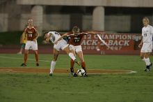 UT freshman Kylie Doniak (#15, Midfielder) tackles the ball as UT sophomore Erica Campanelli (#19, Defender) watches.  The University of Texas women's soccer team tied 0-0 against the Texas A&M Aggies Friday night, September 27, 2008.

Filename: SRM_20080926_1942066.jpg
Aperture: f/4.0
Shutter Speed: 1/500
Body: Canon EOS-1D Mark II
Lens: Canon EF 300mm f/2.8 L IS