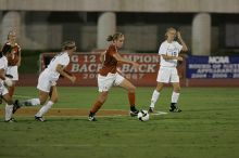 UT freshman Kylie Doniak (#15, Midfielder) tackles the ball as UT sophomore Erica Campanelli (#19, Defender) watches.  The University of Texas women's soccer team tied 0-0 against the Texas A&M Aggies Friday night, September 27, 2008.

Filename: SRM_20080926_1942081.jpg
Aperture: f/4.0
Shutter Speed: 1/500
Body: Canon EOS-1D Mark II
Lens: Canon EF 300mm f/2.8 L IS