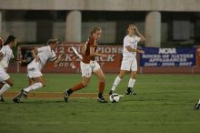 UT freshman Kylie Doniak (#15, Midfielder) tackles the ball as UT sophomore Erica Campanelli (#19, Defender) watches.  The University of Texas women's soccer team tied 0-0 against the Texas A&M Aggies Friday night, September 27, 2008.

Filename: SRM_20080926_1942082.jpg
Aperture: f/4.0
Shutter Speed: 1/500
Body: Canon EOS-1D Mark II
Lens: Canon EF 300mm f/2.8 L IS