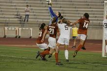 UT senior Dianna Pfenninger (#8, Goalkeeper) jumps up to block the shot on goal as UT senior Courtney Gaines (#23, Midfielder), UT junior Emily Anderson (#21, Forward), and UT senior Kasey Moore (#14, Defender) watch.  The University of Texas women's soccer team tied 0-0 against the Texas A&M Aggies Friday night, September 27, 2008.

Filename: SRM_20080926_2023500.jpg
Aperture: f/4.0
Shutter Speed: 1/400
Body: Canon EOS-1D Mark II
Lens: Canon EF 300mm f/2.8 L IS