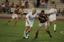 UT junior Emily Anderson (#21, Forward) plays defense on A&M #33.  The University of Texas women's soccer team tied 0-0 against the Texas A&M Aggies Friday night, September 27, 2008.

Filename: SRM_20080926_2027400.jpg
Aperture: f/2.8
Shutter Speed: 1/640
Body: Canon EOS-1D Mark II
Lens: Canon EF 300mm f/2.8 L IS