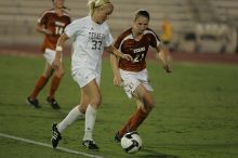 UT junior Emily Anderson (#21, Forward) plays defense on A&M #33.  The University of Texas women's soccer team tied 0-0 against the Texas A&M Aggies Friday night, September 27, 2008.

Filename: SRM_20080926_2027440.jpg
Aperture: f/2.8
Shutter Speed: 1/640
Body: Canon EOS-1D Mark II
Lens: Canon EF 300mm f/2.8 L IS