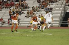 UT junior Emily Anderson (#21, Forward) passes the ball upfield with UT senior Kasey Moore (#14, Defender) watching.  The University of Texas women's soccer team tied 0-0 against the Texas A&M Aggies Friday night, September 27, 2008.

Filename: SRM_20080926_2039544.jpg
Aperture: f/4.0
Shutter Speed: 1/200
Body: Canon EOS-1D Mark II
Lens: Canon EF 300mm f/2.8 L IS