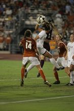 A shot on goal is caught as UT senior Kasey Moore (#14, Defender) and UT junior Emily Anderson (#21, Forward) hope for some action.  The University of Texas women's soccer team tied 0-0 against the Texas A&M Aggies Friday night, September 27, 2008.

Filename: SRM_20080926_2045586.jpg
Aperture: f/2.8
Shutter Speed: 1/500
Body: Canon EOS-1D Mark II
Lens: Canon EF 300mm f/2.8 L IS