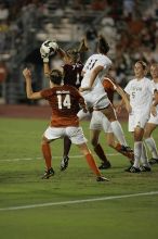 A shot on goal is caught as UT senior Kasey Moore (#14, Defender) and UT junior Emily Anderson (#21, Forward) hope for some action.  The University of Texas women's soccer team tied 0-0 against the Texas A&M Aggies Friday night, September 27, 2008.

Filename: SRM_20080926_2045587.jpg
Aperture: f/2.8
Shutter Speed: 1/500
Body: Canon EOS-1D Mark II
Lens: Canon EF 300mm f/2.8 L IS