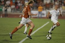 UT freshman Courtney Goodson (#7, Forward and Midfielder) takes the ball down the field.  The University of Texas women's soccer team tied 0-0 against the Texas A&M Aggies Friday night, September 27, 2008.

Filename: SRM_20080926_2048324.jpg
Aperture: f/2.8
Shutter Speed: 1/500
Body: Canon EOS-1D Mark II
Lens: Canon EF 300mm f/2.8 L IS