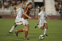 UT freshman Courtney Goodson (#7, Forward and Midfielder) takes the ball down the field.  The University of Texas women's soccer team tied 0-0 against the Texas A&M Aggies Friday night, September 27, 2008.

Filename: SRM_20080926_2048326.jpg
Aperture: f/2.8
Shutter Speed: 1/500
Body: Canon EOS-1D Mark II
Lens: Canon EF 300mm f/2.8 L IS