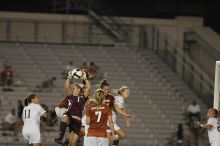 A&M goalkeeper catches another shot on goal as UT senior Kasey Moore (#14, Defender) and UT freshman Lucy Keith (#6, Midfielder) attempt the header and UT freshman Courtney Goodson (#7, Forward and Midfielder) watches.  The University of Texas women's soccer team tied 0-0 against the Texas A&M Aggies Friday night, September 27, 2008.

Filename: SRM_20080926_2049480.jpg
Aperture: f/2.8
Shutter Speed: 1/500
Body: Canon EOS-1D Mark II
Lens: Canon EF 300mm f/2.8 L IS