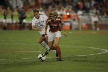 UT sophomore Niki Arlitt (#11, Forward) steals the ball from an Aggie.  The University of Texas women's soccer team tied 0-0 against the Texas A&M Aggies Friday night, September 27, 2008.

Filename: SRM_20080926_2056086.jpg
Aperture: f/2.8
Shutter Speed: 1/640
Body: Canon EOS-1D Mark II
Lens: Canon EF 300mm f/2.8 L IS