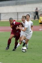 UT senior Stephanie Logterman (#10, Defender) and UT junior Emily Anderson (#21, Forward) team up on Iowa State #16.  The University of Texas women's soccer team won 2-1 against the Iowa State Cyclones Sunday afternoon, October 5, 2008.

Filename: SRM_20081005_12051854.jpg
Aperture: f/5.6
Shutter Speed: 1/1250
Body: Canon EOS-1D Mark II
Lens: Canon EF 300mm f/2.8 L IS