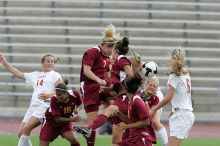 UT freshman Courtney Goodson (#7, Forward and Midfielder) attempts a header while UT senior Kasey Moore (#14, Defender) and UT freshman Lucy Keith (#6, Midfielder) watch.  The University of Texas women's soccer team won 2-1 against the Iowa State Cyclones Sunday afternoon, October 5, 2008.

Filename: SRM_20081005_12235034.jpg
Aperture: f/5.6
Shutter Speed: 1/1000
Body: Canon EOS-1D Mark II
Lens: Canon EF 300mm f/2.8 L IS