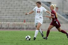 UT junior Stephanie Gibson (#22, Defense and Forward) steals the ball from an Iowa State player.  The University of Texas women's soccer team won 2-1 against the Iowa State Cyclones Sunday afternoon, October 5, 2008.

Filename: SRM_20081005_12364655.jpg
Aperture: f/5.6
Shutter Speed: 1/1250
Body: Canon EOS-1D Mark II
Lens: Canon EF 300mm f/2.8 L IS