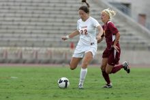 UT junior Stephanie Gibson (#22, Defense and Forward) steals the ball from an Iowa State player.  The University of Texas women's soccer team won 2-1 against the Iowa State Cyclones Sunday afternoon, October 5, 2008.

Filename: SRM_20081005_12364656.jpg
Aperture: f/5.6
Shutter Speed: 1/1250
Body: Canon EOS-1D Mark II
Lens: Canon EF 300mm f/2.8 L IS