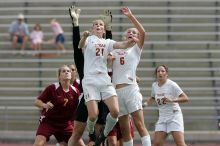 UT junior Emily Anderson (#21, Forward) and UT freshman Lucy Keith (#6, Midfielder) fight for the header with the keeper, as UT junior Stephanie Gibson (#22, Defense and Forward) watches.  The University of Texas women's soccer team won 2-1 against the Iowa State Cyclones Sunday afternoon, October 5, 2008.

Filename: SRM_20081005_12420420.jpg
Aperture: f/5.6
Shutter Speed: 1/1600
Body: Canon EOS-1D Mark II
Lens: Canon EF 300mm f/2.8 L IS