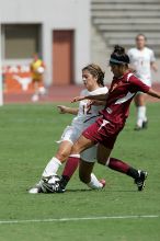 UT sophomore Alisha Ortiz (#12, Forward) withstands a tackle in the second half.  The University of Texas women's soccer team won 2-1 against the Iowa State Cyclones Sunday afternoon, October 5, 2008.

Filename: SRM_20081005_13135493.jpg
Aperture: f/5.6
Shutter Speed: 1/2500
Body: Canon EOS-1D Mark II
Lens: Canon EF 300mm f/2.8 L IS