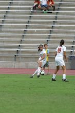 UT freshman Amanda Lisberger (#13, Midfielder) passes the ball to UT senior Stephanie Logterman (#10, Defender) in the second half.  The University of Texas women's soccer team won 2-1 against the Iowa State Cyclones Sunday afternoon, October 5, 2008.