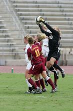 UT freshman Kylie Doniak (#15, Midfielder) and UT sophomore Kate Nicholson (#17, Forward and Midfielder) try for the header but the Iowa State goalkeeper gets to it first in the second half.  The University of Texas women's soccer team won 2-1 against the Iowa State Cyclones Sunday afternoon, October 5, 2008.

Filename: SRM_20081005_13403041.jpg
Aperture: f/5.6
Shutter Speed: 1/1250
Body: Canon EOS-1D Mark II
Lens: Canon EF 300mm f/2.8 L IS