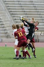 UT freshman Kylie Doniak (#15, Midfielder) and UT sophomore Kate Nicholson (#17, Forward and Midfielder) try for the header but the Iowa State goalkeeper gets to it first in the second half.  The University of Texas women's soccer team won 2-1 against the Iowa State Cyclones Sunday afternoon, October 5, 2008.

Filename: SRM_20081005_13403242.jpg
Aperture: f/5.6
Shutter Speed: 1/1250
Body: Canon EOS-1D Mark II
Lens: Canon EF 300mm f/2.8 L IS