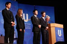 Former President Bill Clinton hands out commitment certificates to CGIU attendees for their exceptional pledges to the CGI cause during the opening plenary session of the CGIU meeting.  Day one of the 2nd Annual Clinton Global Initiative University (CGIU) meeting was held at The University of Texas at Austin, Friday, February 13, 2009.