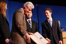 Former President Bill Clinton hands out commitment certificates to CGIU attendees for their exceptional pledges to the CGI cause during the opening plenary session of the CGIU meeting.  Day one of the 2nd Annual Clinton Global Initiative University (CGIU) meeting was held at The University of Texas at Austin, Friday, February 13, 2009.