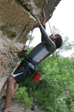 Javier Morales top rope climbing Diving for Rocks (5.10d), photographed from  the third bolt of Magster (5.10a).  It was another long day of rock climbing at Seismic Wall on Austin's Barton Creek Greenbelt, Saturday, April 11, 2009.

Filename: SRM_20090411_16493064.JPG
Aperture: f/5.6
Shutter Speed: 1/320
Body: Canon EOS-1D Mark II
Lens: Canon EF 16-35mm f/2.8 L