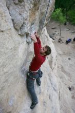 Me top rope climbing Diving for Rocks (5.10d), photographed from  the third bolt of Magster (5.10a) by Andrew Dreher.  It was another long day of rock climbing at Seismic Wall on Austin's Barton Creek Greenbelt, Saturday, April 11, 2009.

Filename: SRM_20090411_17101347.JPG
Aperture: f/5.6
Shutter Speed: 1/320
Body: Canon EOS-1D Mark II
Lens: Canon EF 16-35mm f/2.8 L