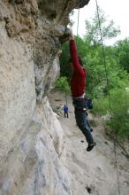 Me top rope climbing Diving for Rocks (5.10d), photographed from  the third bolt of Magster (5.10a) by Andrew Dreher.  It was another long day of rock climbing at Seismic Wall on Austin's Barton Creek Greenbelt, Saturday, April 11, 2009.

Filename: SRM_20090411_17165554.JPG
Aperture: f/5.6
Shutter Speed: 1/320
Body: Canon EOS-1D Mark II
Lens: Canon EF 16-35mm f/2.8 L