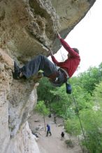 Me top rope climbing Diving for Rocks (5.10d), photographed from  the third bolt of Magster (5.10a) by Andrew Dreher.  It was another long day of rock climbing at Seismic Wall on Austin's Barton Creek Greenbelt, Saturday, April 11, 2009.

Filename: SRM_20090411_17170970.JPG
Aperture: f/5.6
Shutter Speed: 1/320
Body: Canon EOS-1D Mark II
Lens: Canon EF 16-35mm f/2.8 L