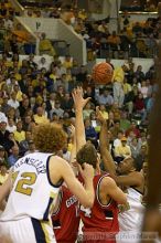 B.J. Elder goes up for the ball as Luke Schenscher looks on.  Men's Basketball Georgia Tech beat UGA 87-49.

Filename: crw_5980_std.jpg
Aperture: f/2.8
Shutter Speed: 1/640
Body: Canon EOS DIGITAL REBEL
Lens: Canon EF 80-200mm f/2.8 L