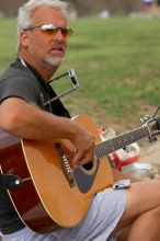 Woode Wood playing his acoustic guitar at Town Lake Hike & Bike trail in Austin, TX.

Filename: SRM_20060312_094302_8.jpg
Aperture: f/4.0
Shutter Speed: 1/800
Body: Canon EOS 20D
Lens: Canon EF 80-200mm f/2.8 L