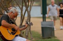 Woode Wood playing his acoustic guitar at Town Lake Hike & Bike trail in Austin, TX.

Filename: SRM_20060312_094536_3.jpg
Aperture: f/4.0
Shutter Speed: 1/1000
Body: Canon EOS 20D
Lens: Canon EF 80-200mm f/2.8 L