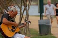 Woode Wood playing his acoustic guitar at Town Lake Hike & Bike trail in Austin, TX.

Filename: SRM_20060312_094538_4.jpg
Aperture: f/4.0
Shutter Speed: 1/1000
Body: Canon EOS 20D
Lens: Canon EF 80-200mm f/2.8 L
