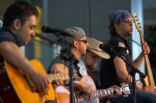 The Gene Pool, performing at the Austin airport.  Geno Stroia II on vocals/guitar, Jorge Castillo on vocals/guitar, Travis Woodard on drums and Steven Ray Will on vocals/bass guitar.

Filename: SRM_20060518_155010_6.jpg
Aperture: f/2.8
Shutter Speed: 1/200
Body: Canon EOS 20D
Lens: Canon EF 80-200mm f/2.8 L