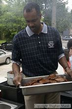 Coach Paul Hewitt carries the hamburgers he just grilled at AXO Thursday night.  AXO was the winning sorority for the basketball attendance competition.

Filename: crw_0055_std.jpg
Aperture: f/6.3
Shutter Speed: 1/80
Body: Canon EOS DIGITAL REBEL
Lens: Sigma 15-30mm f/3.5-4.5 EX Aspherical DG DF