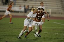 UT junior Emily Anderson (#21, Forward) plays defense on A&M #33.  The University of Texas women's soccer team tied 0-0 against the Texas A&M Aggies Friday night, September 27, 2008.

Filename: SRM_20080926_2027423.jpg
Aperture: f/2.8
Shutter Speed: 1/640
Body: Canon EOS-1D Mark II
Lens: Canon EF 300mm f/2.8 L IS